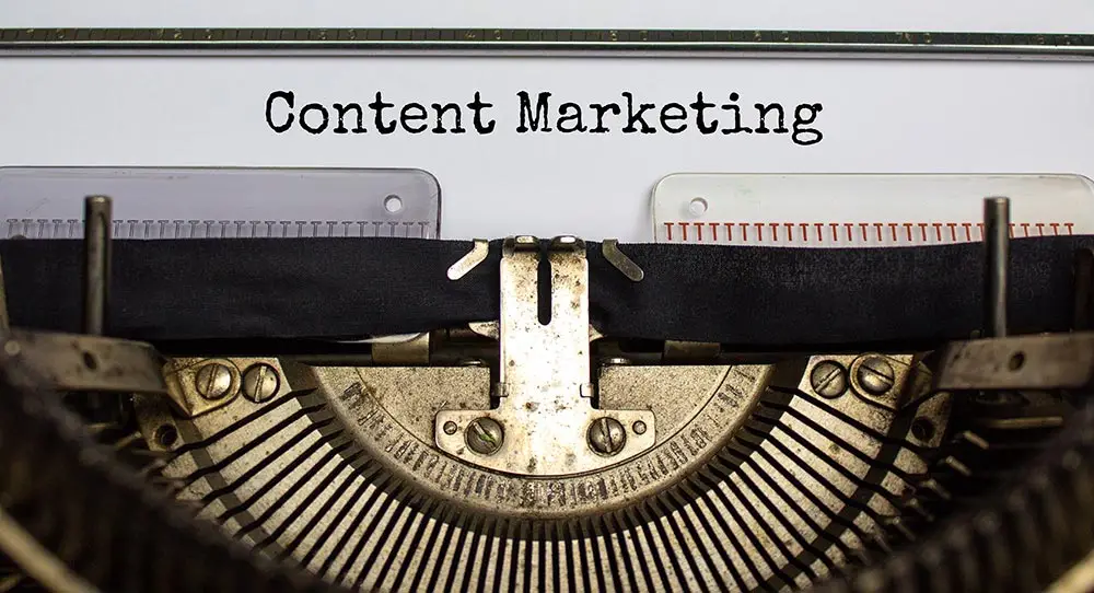 typewriter with content marketing typed out
